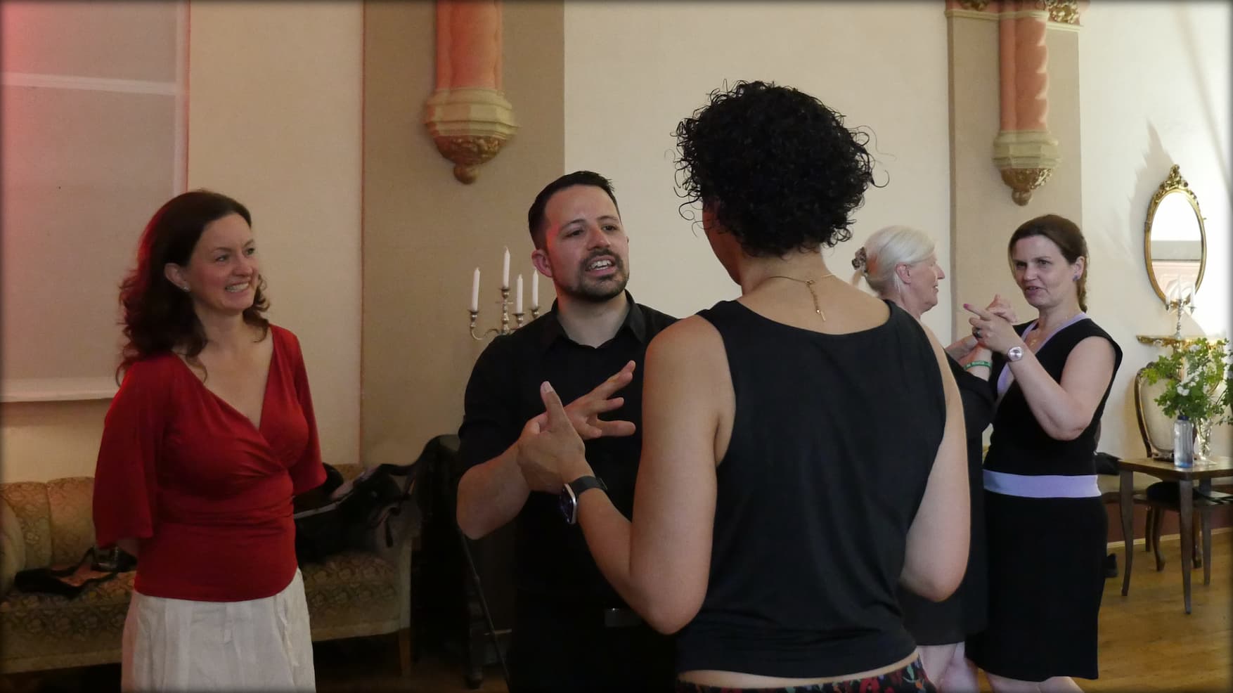 Tango teacher Fadi in direct conversation with a student, discussing her points