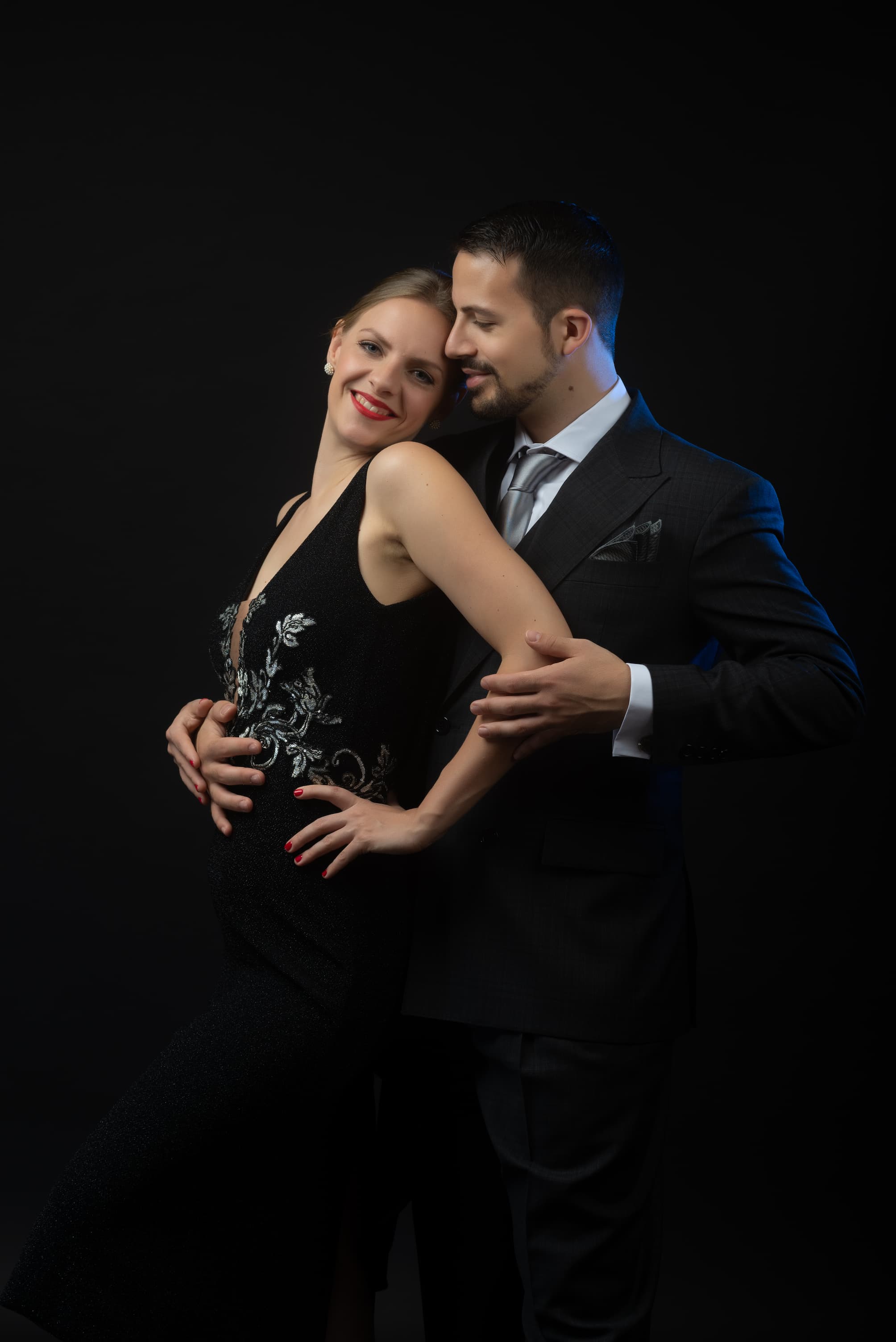 Juliana and Fadi standing joyfully and closely together, elegantly dressed
