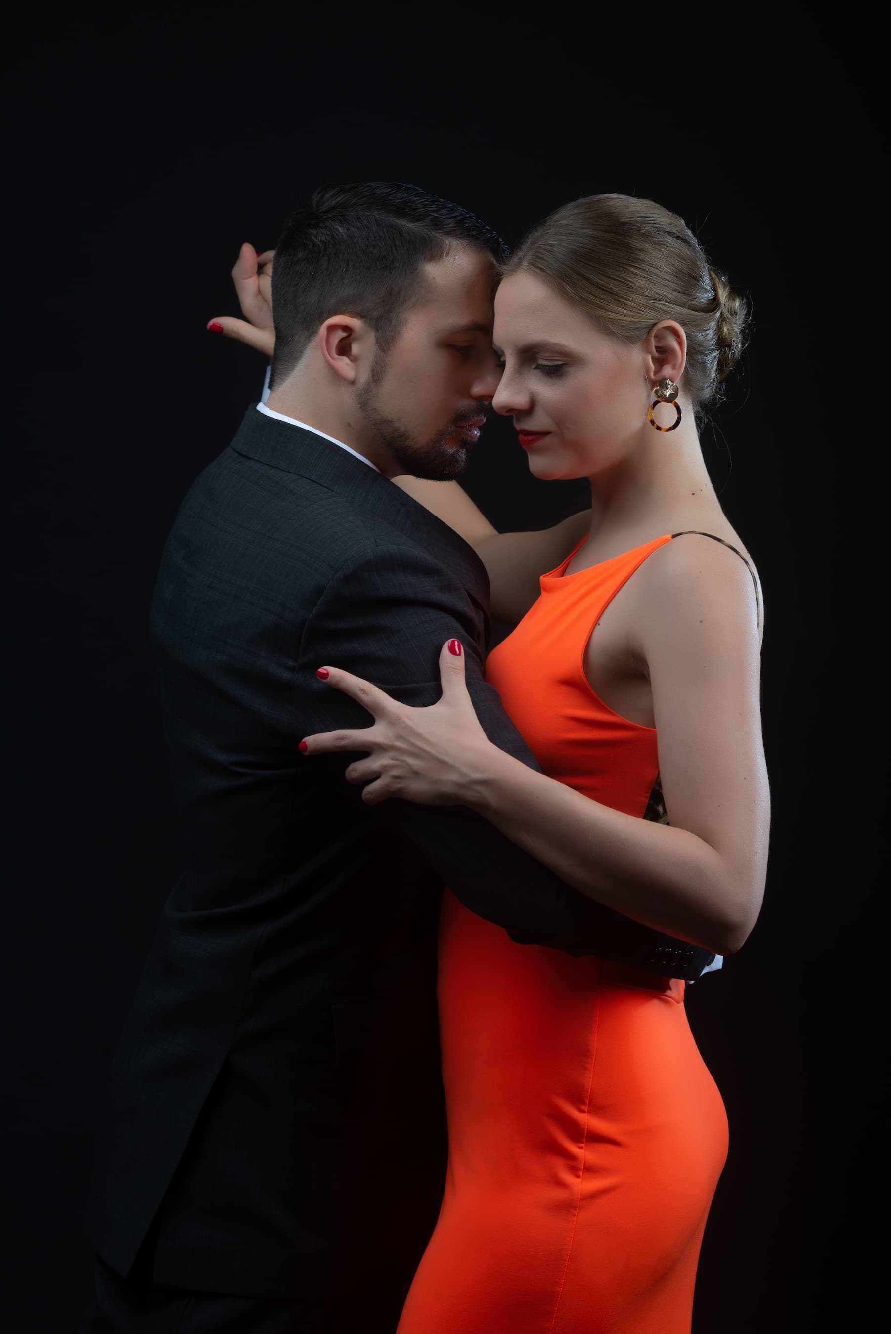Juliana and Fadi in a passionate tango embrace, elegantly dressed